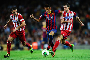 BARCELONA, SPAIN - AUGUST 28:  Neymar (C) of FC Barcelona duels for the ball with Mario Suarez (R) and Gabi Fernandez of Atletico de Madrid during the Spanish Super Cup second leg match between FC Barcelona and Atletico de Madrid at Nou Camp on August 28, 2013 in Barcelona, Spain.  (Photo by David Ramos/Getty Images)